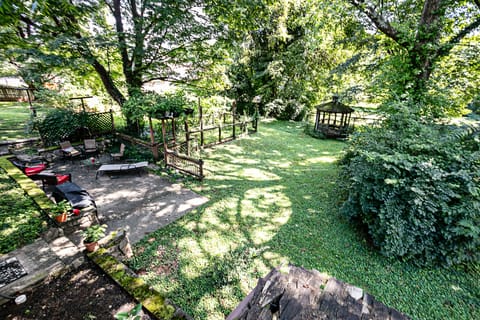 Spacious, unfenced backyard with grill