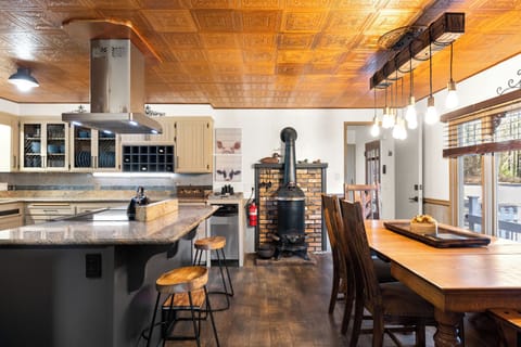 Open kitchen with dining and bar seating