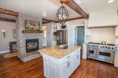 Kitchen with Stacked Stone Fireplace and Flat Screen TV