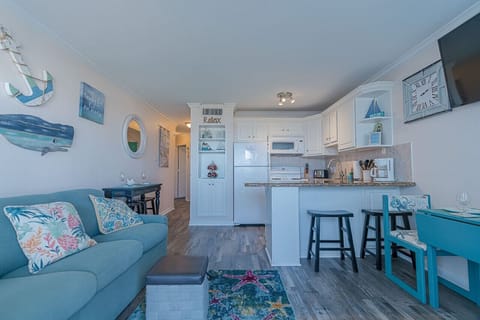 An open-concept living area featuring a flat-screen TV and a comfortable sofa sleeper