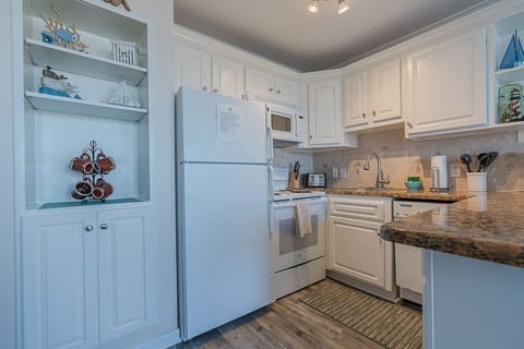 A light and bright open-concept kitchen with spacious counters, modern appliances, and plenty of natural light flowing in.