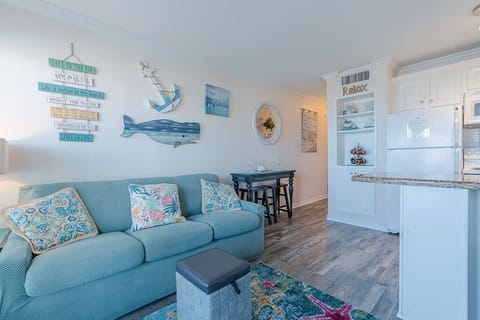 The space is decorated in light, coastal colors, with comfortable furniture and a relaxed, inviting atmosphere.