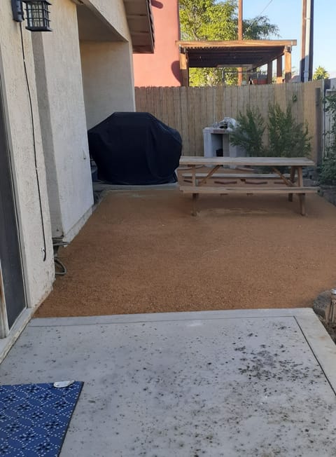 Bar-b-Que and small chimenea in back yard with picnic table seating