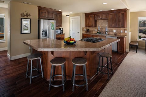 Open kitchen and dining area with additional bar seating.