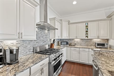 Kitchen with gas stove, two refrigerators and two dishwashers