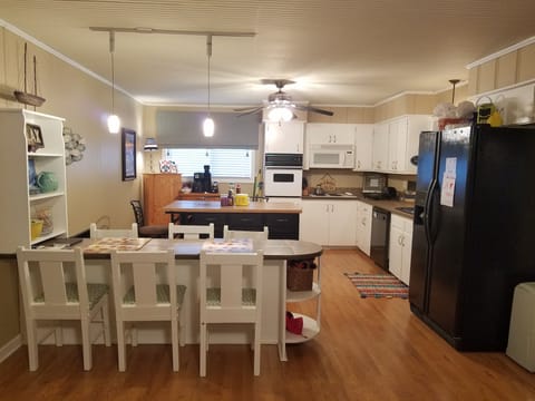 Kitchen and bar connected to main living area and opens into the sunroom.