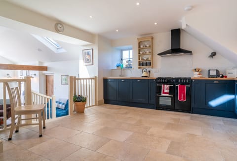 Split level ground floor: Spacious kitchen with steps leading down to sitting room