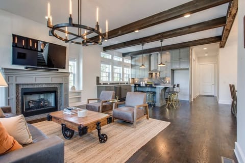 - Experience open-concept living with beams and a cozy fireplace   - Spacious layout flows into a bright modern kitchen   - Comfortable seating makes this home perfect for gatherings