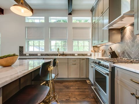 - Cook in this modern kitchen with stainless appliances and bright windows   - Marble counters and ample cabinetry offer elevated convenience   - Open layout makes meal prep and hosting incredibly smooth