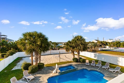 Soak up the Florida sunshine in your private pool oasis, surrounded by tropical palms and just steps from your private sand volleyball court.