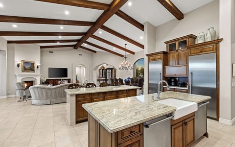 Chef’s kitchen w/ granite island, wood cabinets, stainless appliances & dinning