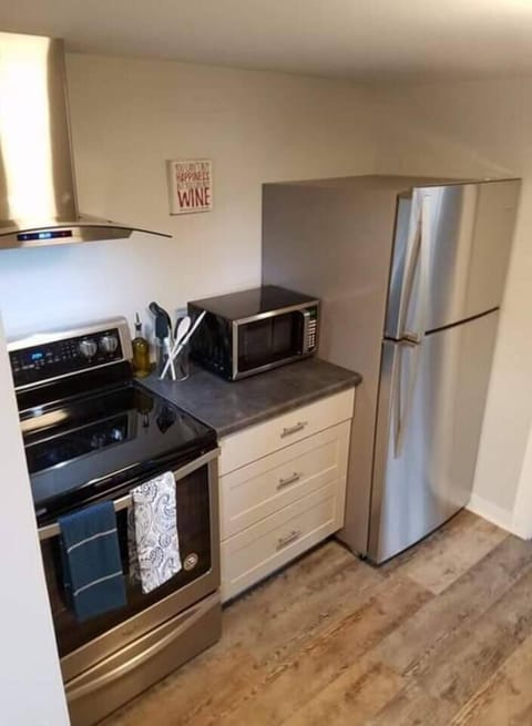 Stove, fridge, and all basic cooking utensils to make a basic meal including pots, pans, dishes, and silverware 