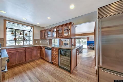 Entry level gourmet kitchen with a barbecue outside on deck