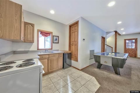 Kitchenette on bottom floor with game room. There are two bedrooms on this floor