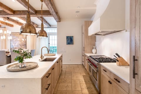 Kitchen with Island, Dual Refrigerators, and Ceiling Lamps.