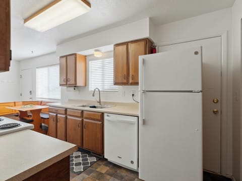 The kitchen is fully stocked with cookware, dishes, utensils and appliances.