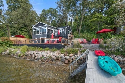 Cabin view from the dock with multi level deck and parking above the cabin .