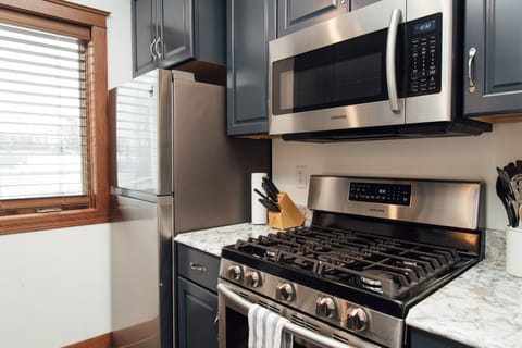 Fully equipped kitchen with pots, pans, and basic kitchen supplies.