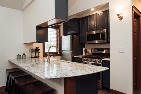 Fully equipped kitchen with pots, pans, and basic kitchen supplies.