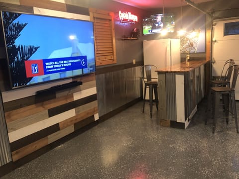 Rec room with bar, tv’s, pinball, shuffle board, arcade system, pool table