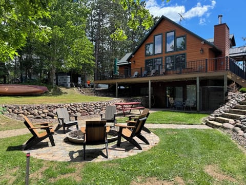 Lakeside deck, firepit, kennel, and covered patio.