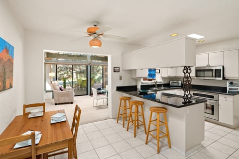 The kitchen has modern appliances and amenities with a server hatch through to the dining area