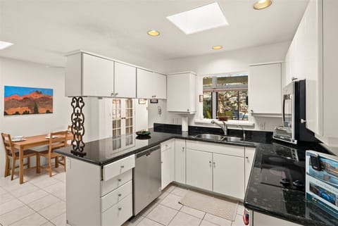 The kitchen is spacious with a dining table that seats 6 with extra seating at the kitchen counter