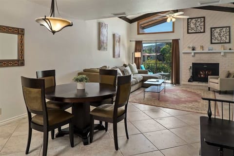 The living area has a large L-shaped sofa and a flat screen TV for entertainment
