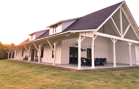 Large, covered patio with space for plenty of seating and an outdoor tv 