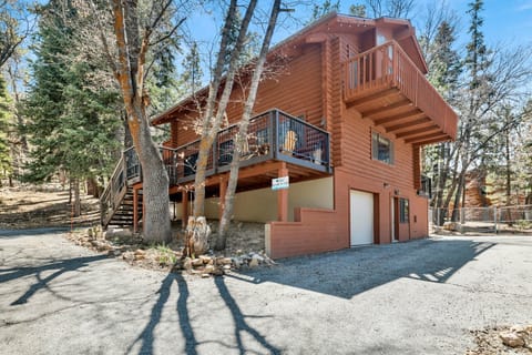 Welcoming cabin entry surrounded by towering pine trees, offering fresh mountain air and a peaceful forest setting—the perfect first impression for your Big Bear Lake getaway.