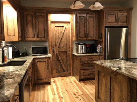 Close-Up of Kitchen - Circle-Milled Pine Cabinetry and Barn Door to Pantry!