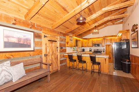 Well-appointed kitchen with 3-chairs at the counter, door access to screened in porch area.