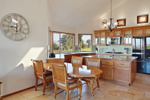 The kitchen features additional dining area for 4