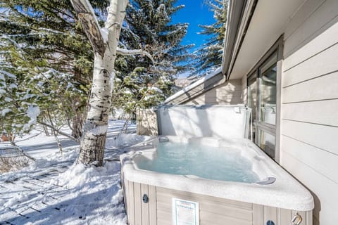 Relax on the back deck of the home in this large private hot tub with mountain views of the slopes at Deer Valley.