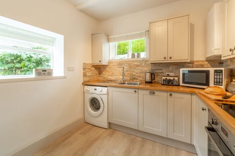 Porthgwidden Cottage, Lelant. Ground floor: Kitchen with oven, hob, dishwasher, washing machine, microwave and fridge/freezer