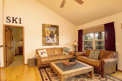 Sink into cozy leather sofas in your mountain retreat, where rustic charm meets comfort beneath vaulted ceilings.
