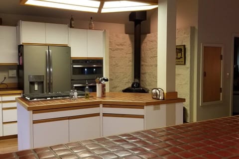 Large kitchen with wood stove for ambience.