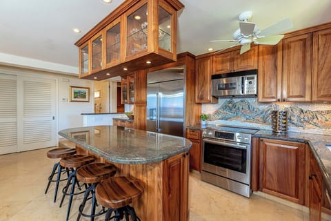 Granite countertops and koa wood cabinets for island style living