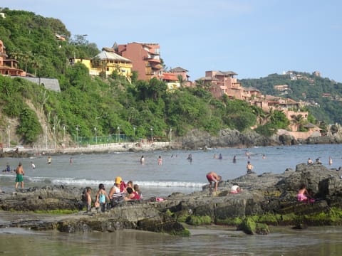 View of beach with homes on the hills