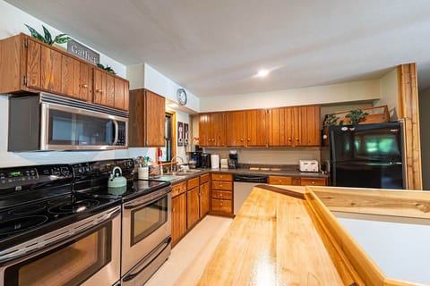 Full size kitchen with 2 electric stoves.
