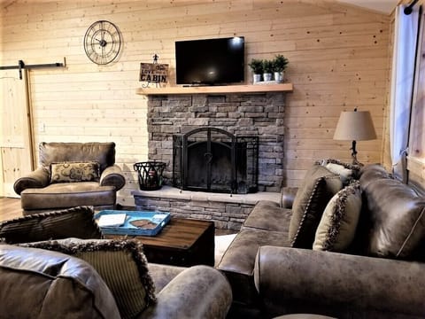 Wood burning fireplace and Roku TV.  Books and games in coffee table.
