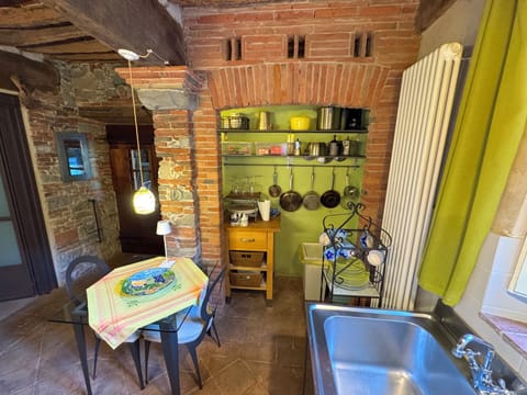 Kitchen with cooking utensil niche.