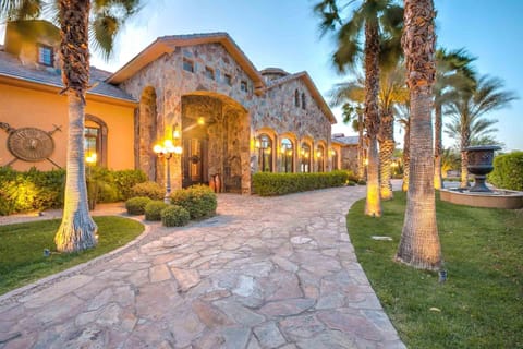 Front Entrance w/ large gated private driveway & palm trees