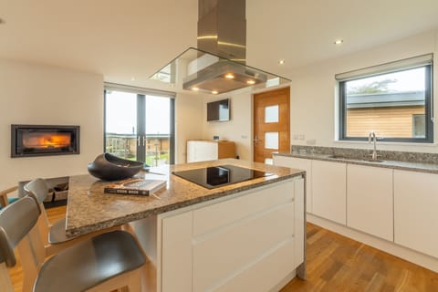 Teyr Mor Cliff, St Agnes. First floor: Kitchen with breakfast bar and stunning wood burning stove