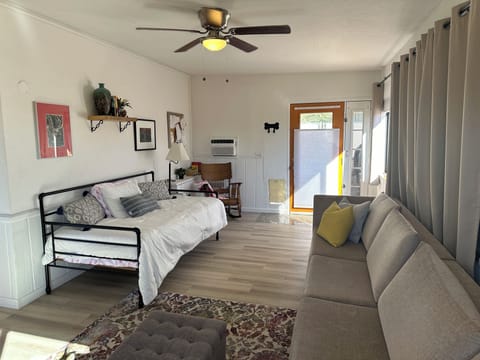 Living room with glass entry door to private patio and plenty of light