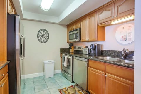 Fully equipped kitchen with dishwasher, refrigerator and freezer, microwave, oven, and electric stovetop