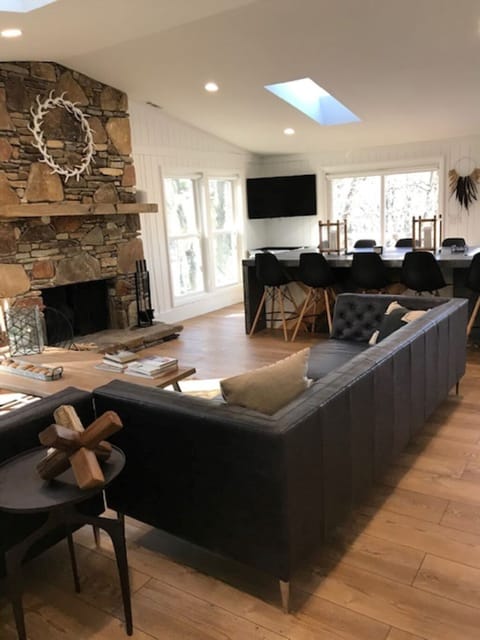 Upstairs living room with vaulted ceilings and panoramic lake views.