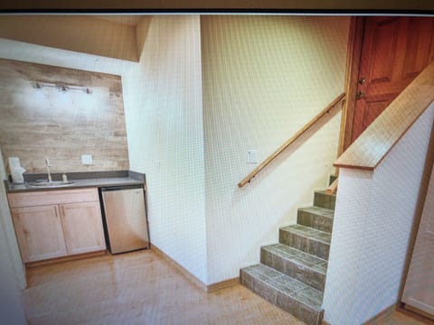 Lower Level Stairs to Garage and Refrigerator, Sink, Vanity
