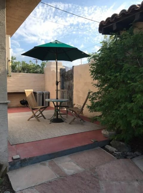 Patio for eating outdoors and there’s a barbecue in the rear.