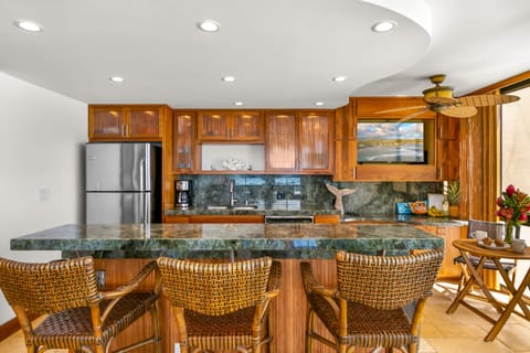 Fully stocked kitchen and comfortable bar with views and TV.